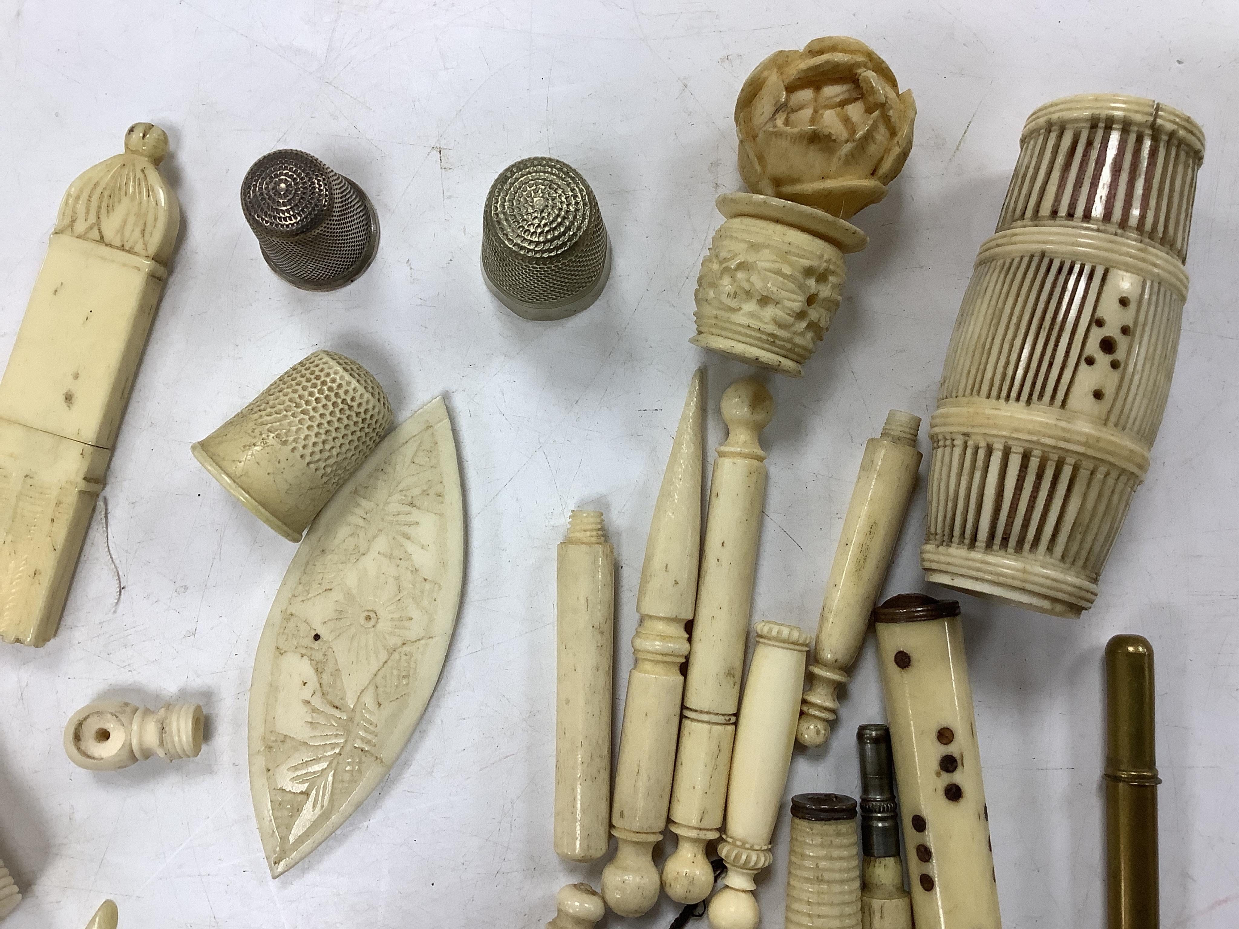 A collection of early 19th century and later bone needlework bodkin cases, two thimbles etc. Condition- some wear and a few items cracked